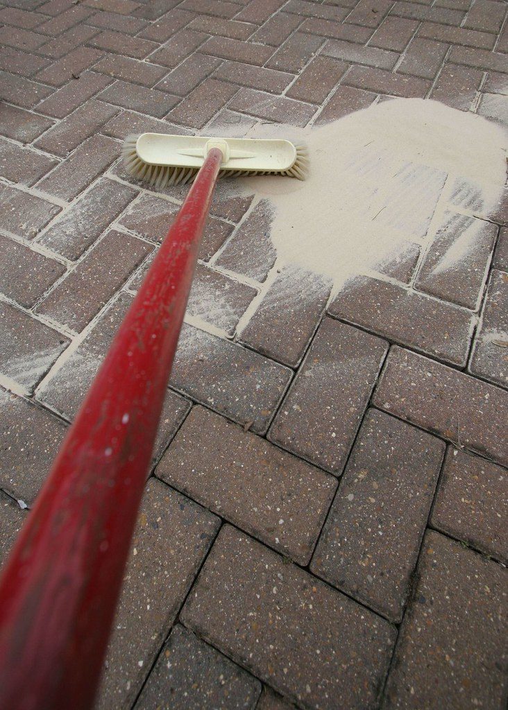 Pressure washing a paved surface